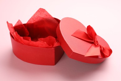 Photo of Heart-shaped gift box with beautiful lid on pink background