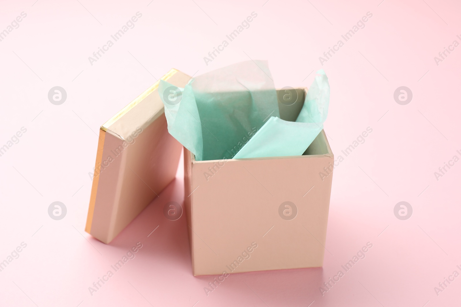 Photo of Open gift box with lid on pink background