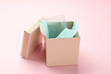 Photo of Open gift box with lid on pink background