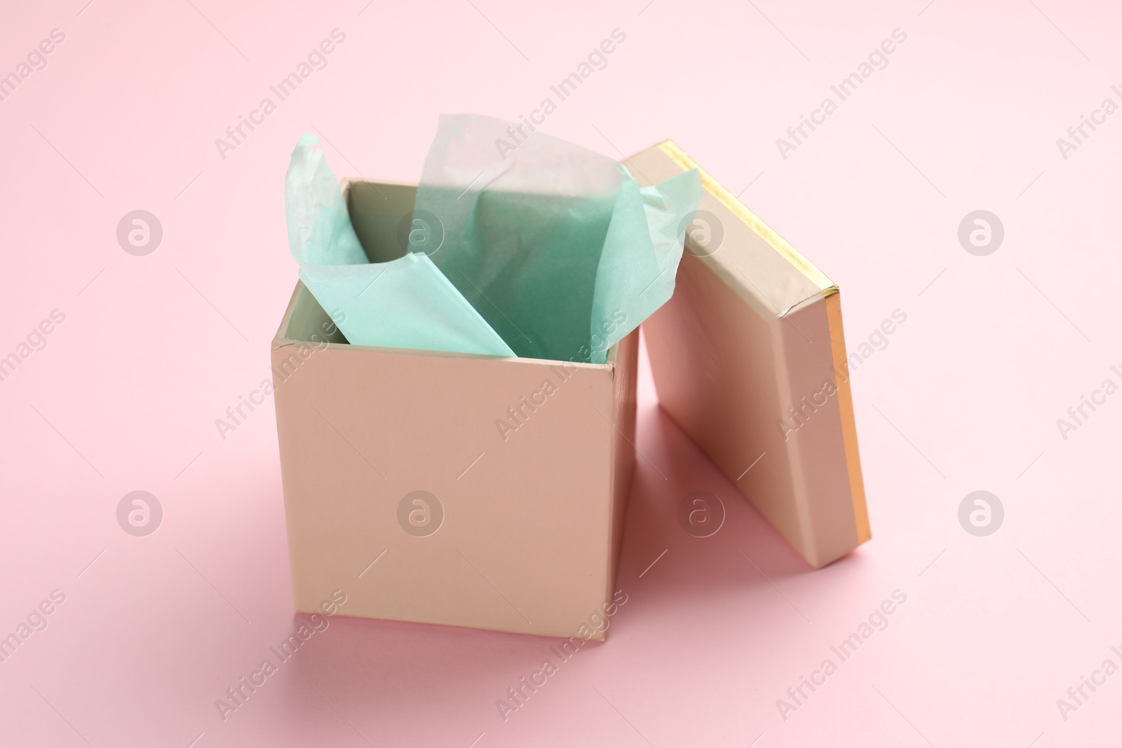 Photo of Open gift box with lid on pink background