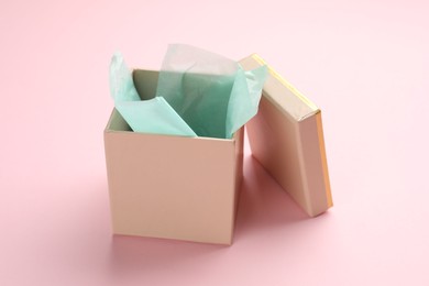 Photo of Open gift box with lid on pink background