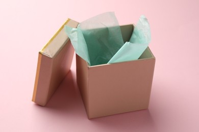 Photo of Open gift box with lid on pink background, closeup
