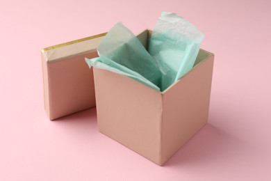 Photo of Open gift box with lid on pink background, closeup