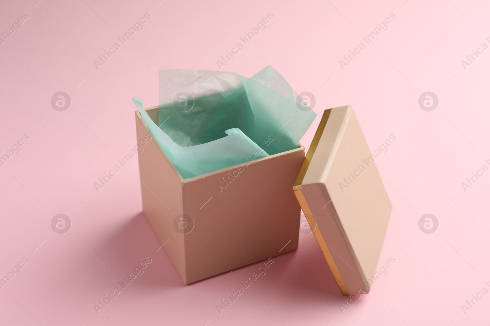 Photo of Open gift box with lid on pink background
