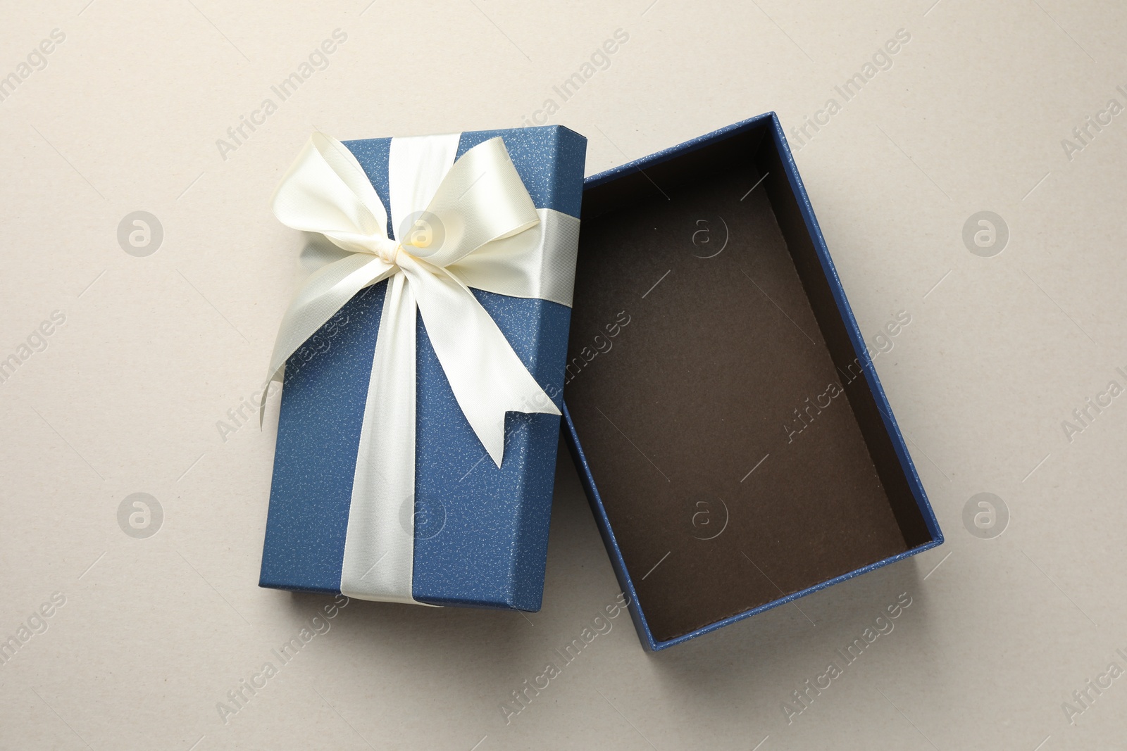 Photo of Open gift box with beautiful lid on light grey background, top view