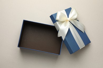 Photo of Open gift box with beautiful lid on light grey background, top view