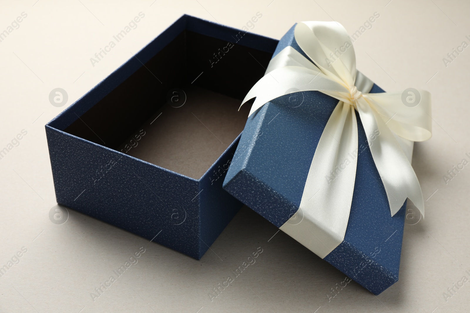 Photo of Open gift box with beautiful lid on light grey background