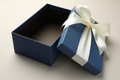 Photo of Open gift box with beautiful lid on light grey background