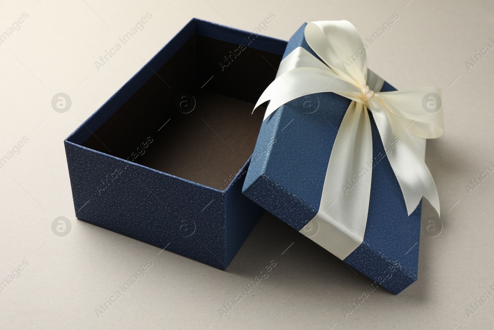 Photo of Open gift box with beautiful lid on light grey background