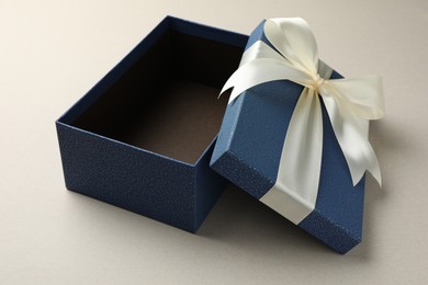 Photo of Open gift box with beautiful lid on light grey background
