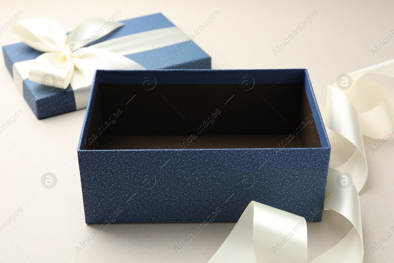 Photo of Open gift box with beautiful lid on light grey background