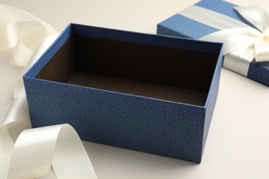 Photo of Open gift box with beautiful lid on light grey background