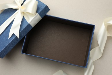 Photo of Open gift box with beautiful lid on light grey background, top view