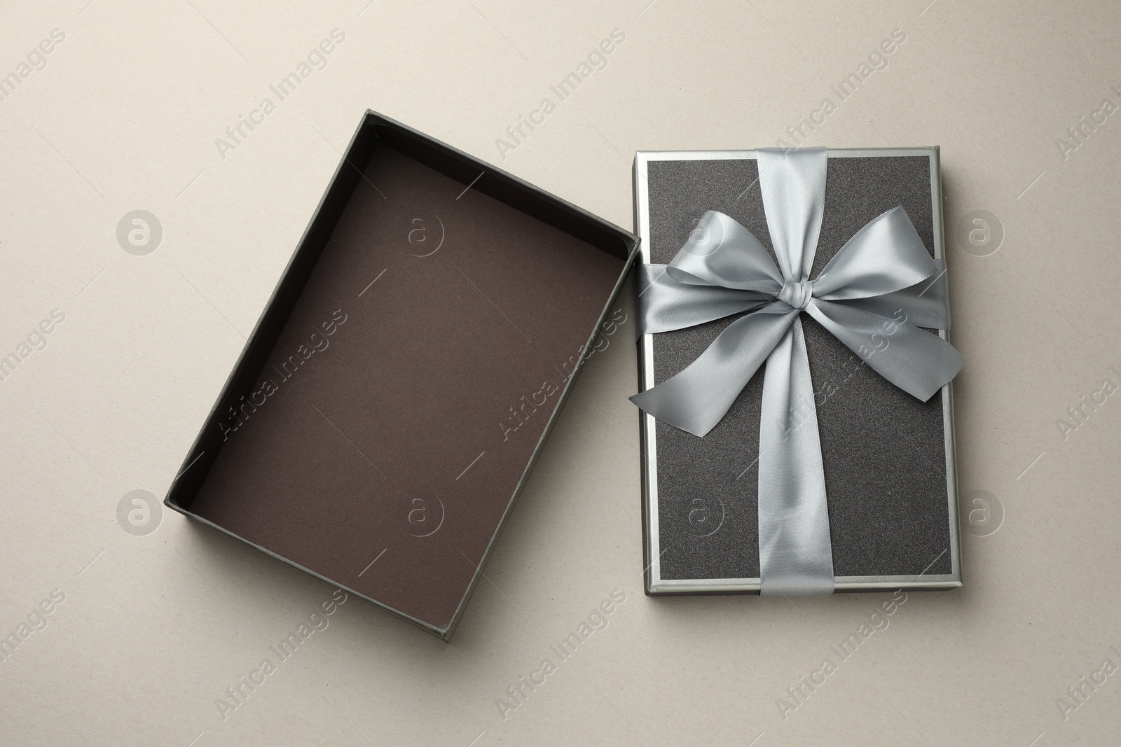 Photo of Open gift box with beautiful lid on light grey background, top view