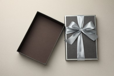 Photo of Open gift box with beautiful lid on light grey background, top view