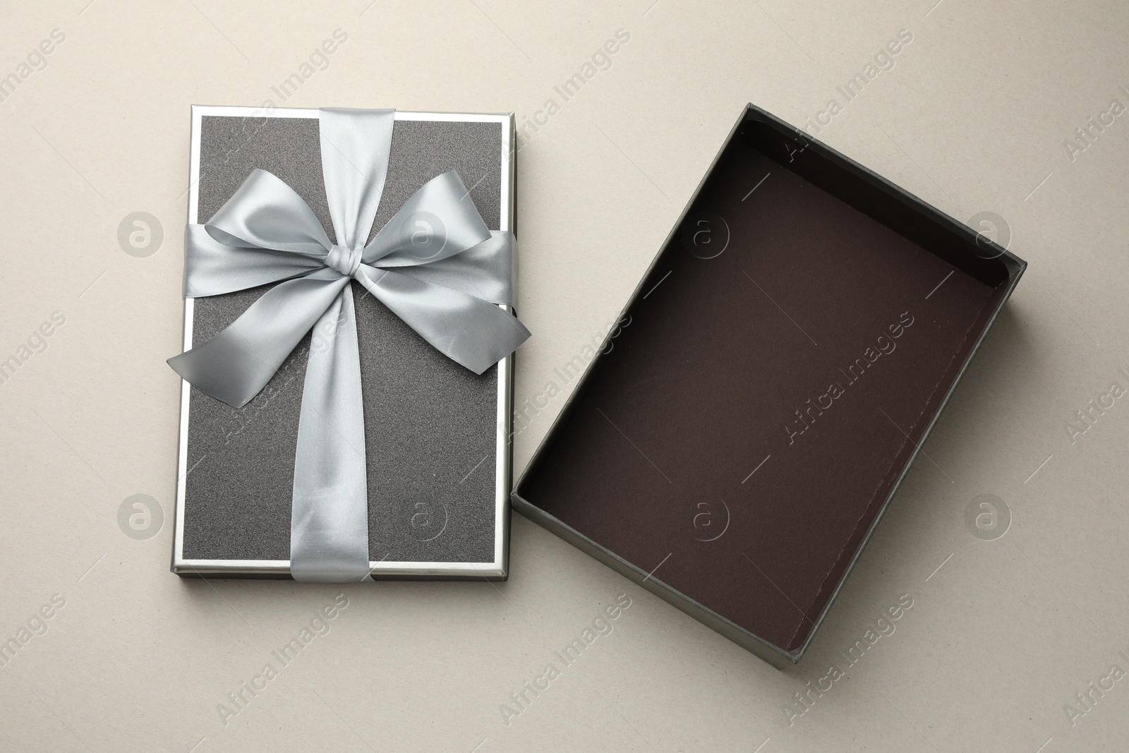 Photo of Open gift box with beautiful lid on light grey background, top view
