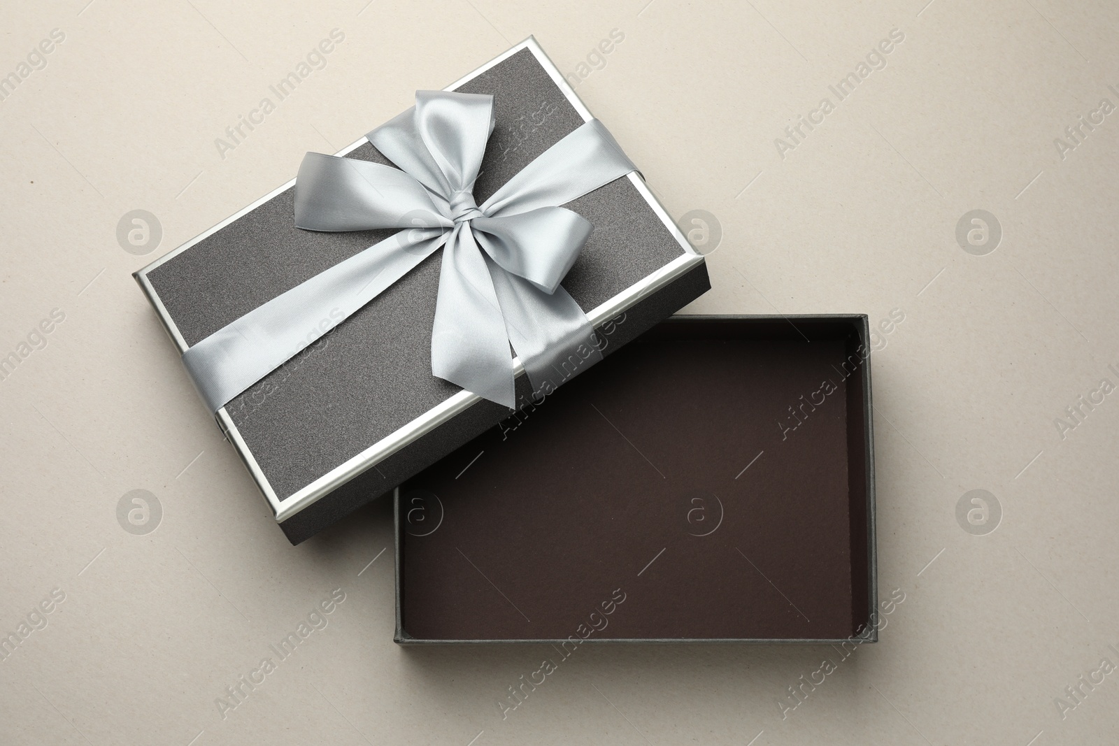 Photo of Open gift box with beautiful lid on light grey background, top view