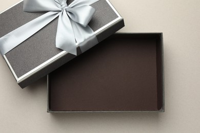 Photo of Open gift box with beautiful lid on light grey background, top view