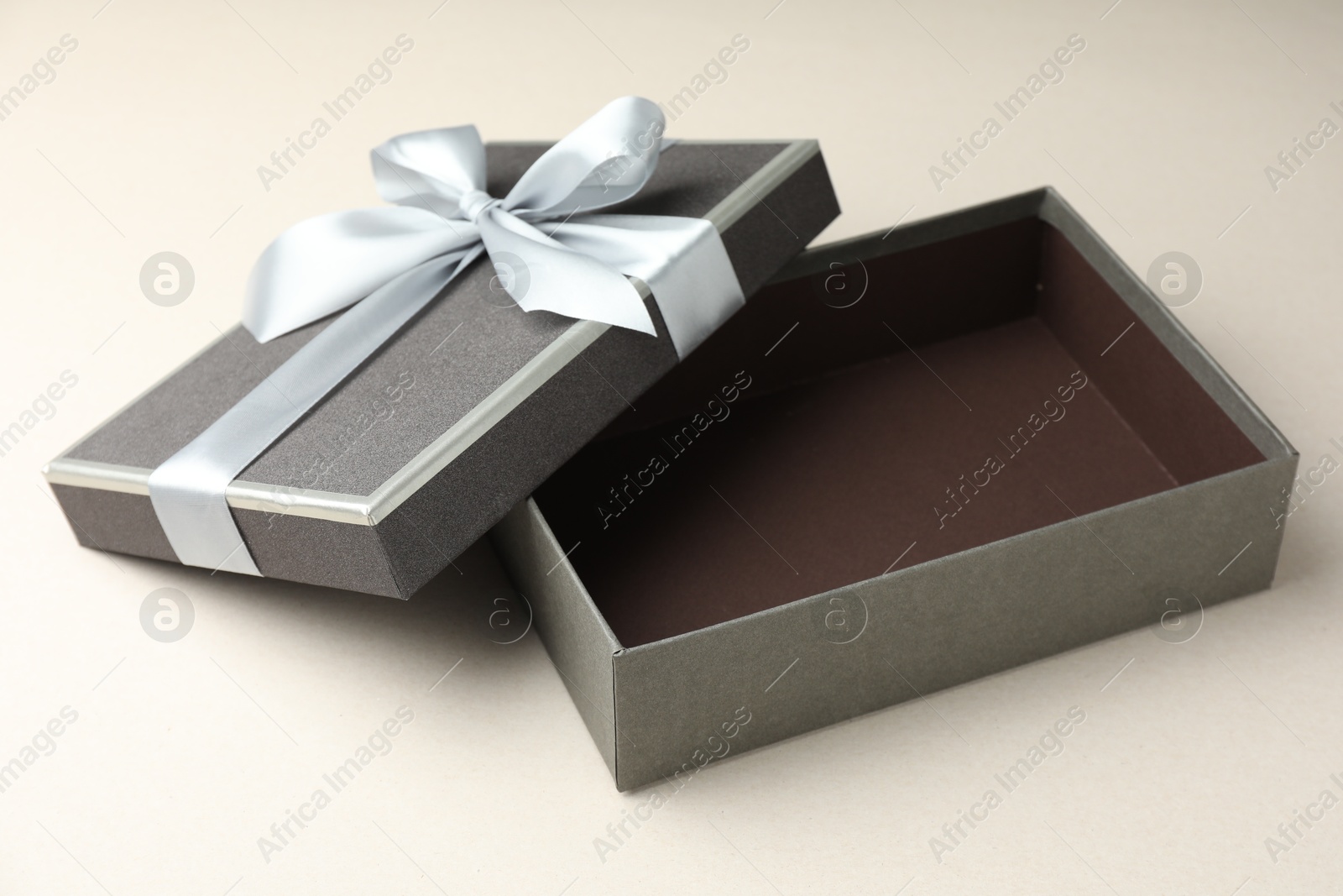 Photo of Open gift box with beautiful lid on light grey background