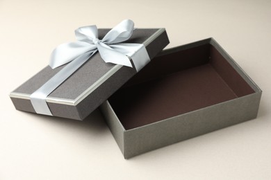 Photo of Open gift box with beautiful lid on light grey background