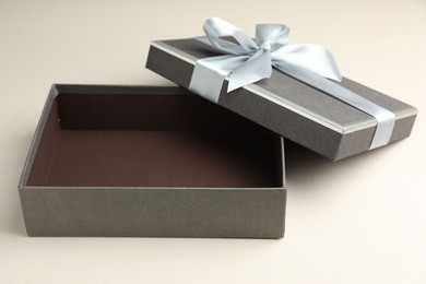 Photo of Open gift box with beautiful lid on light grey background