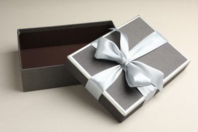Photo of Open gift box with beautiful lid on light grey background