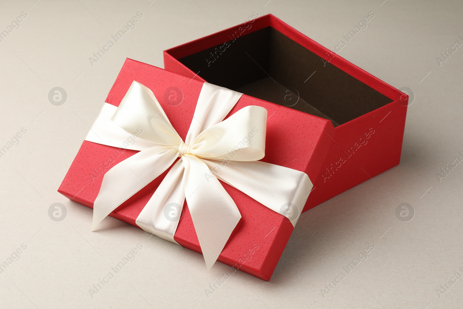 Photo of Open gift box with beautiful lid on light grey background