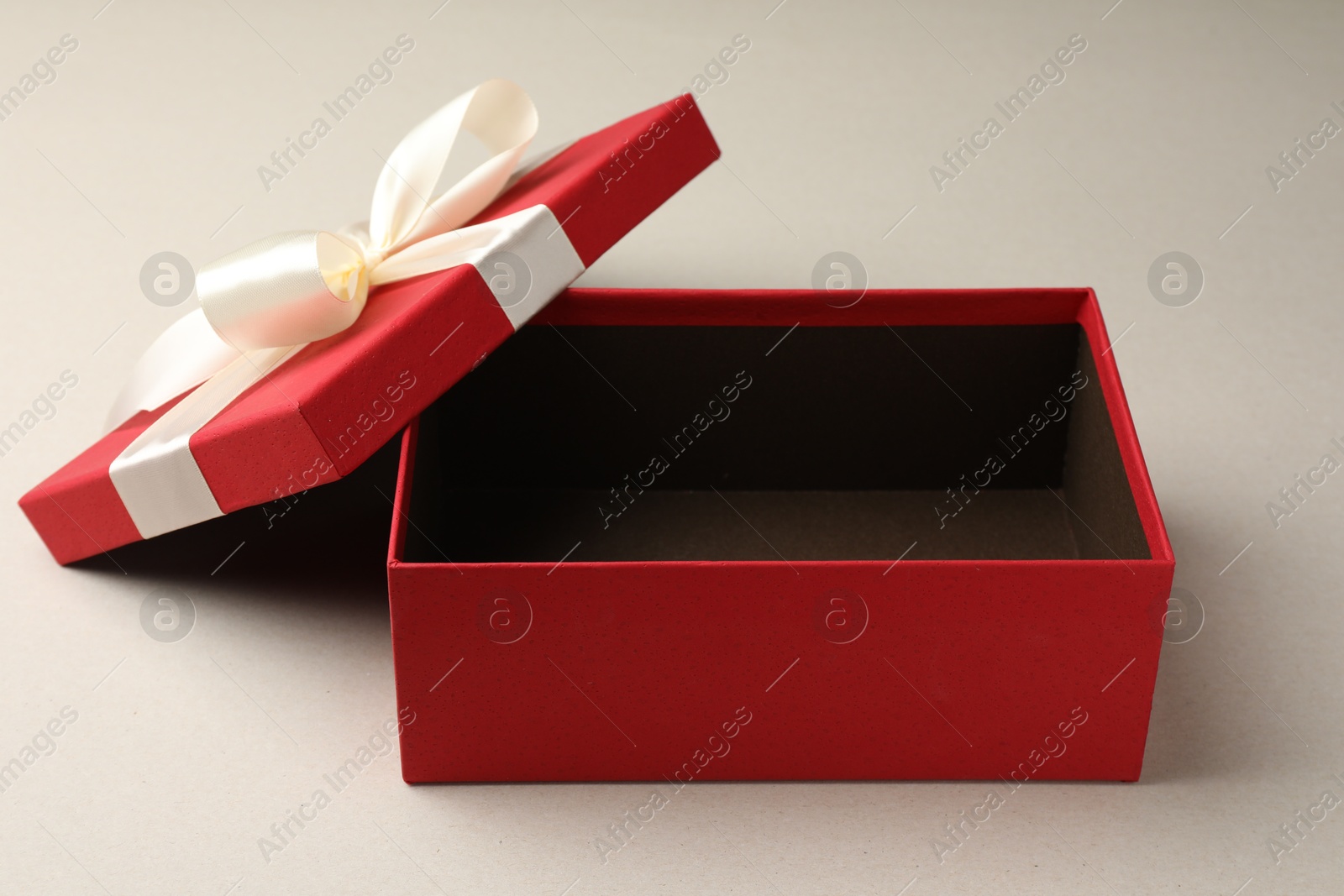 Photo of Open gift box with beautiful lid on light grey background
