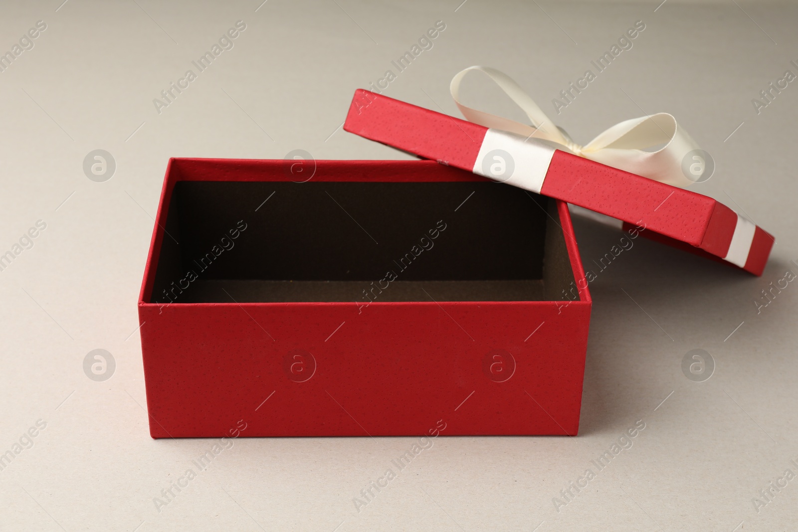 Photo of Open gift box with beautiful lid on light grey background