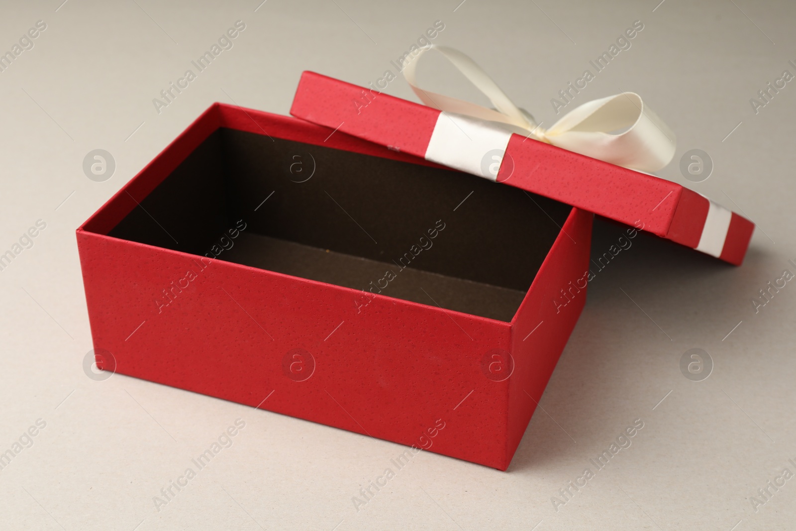 Photo of Open gift box with beautiful lid on light grey background