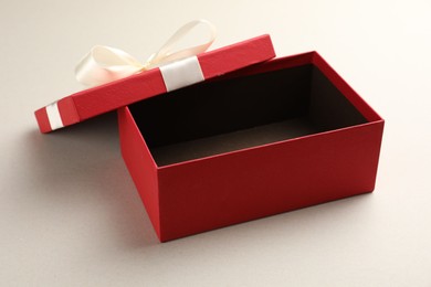 Photo of Open gift box with beautiful lid on light background