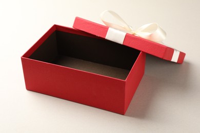 Photo of Open gift box with beautiful lid on light background