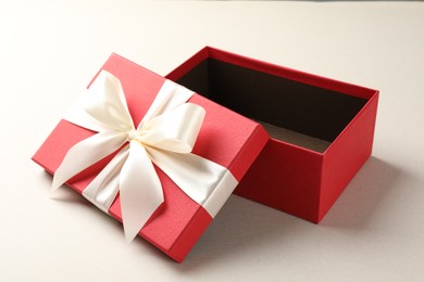 Photo of Open gift box with beautiful lid on light background