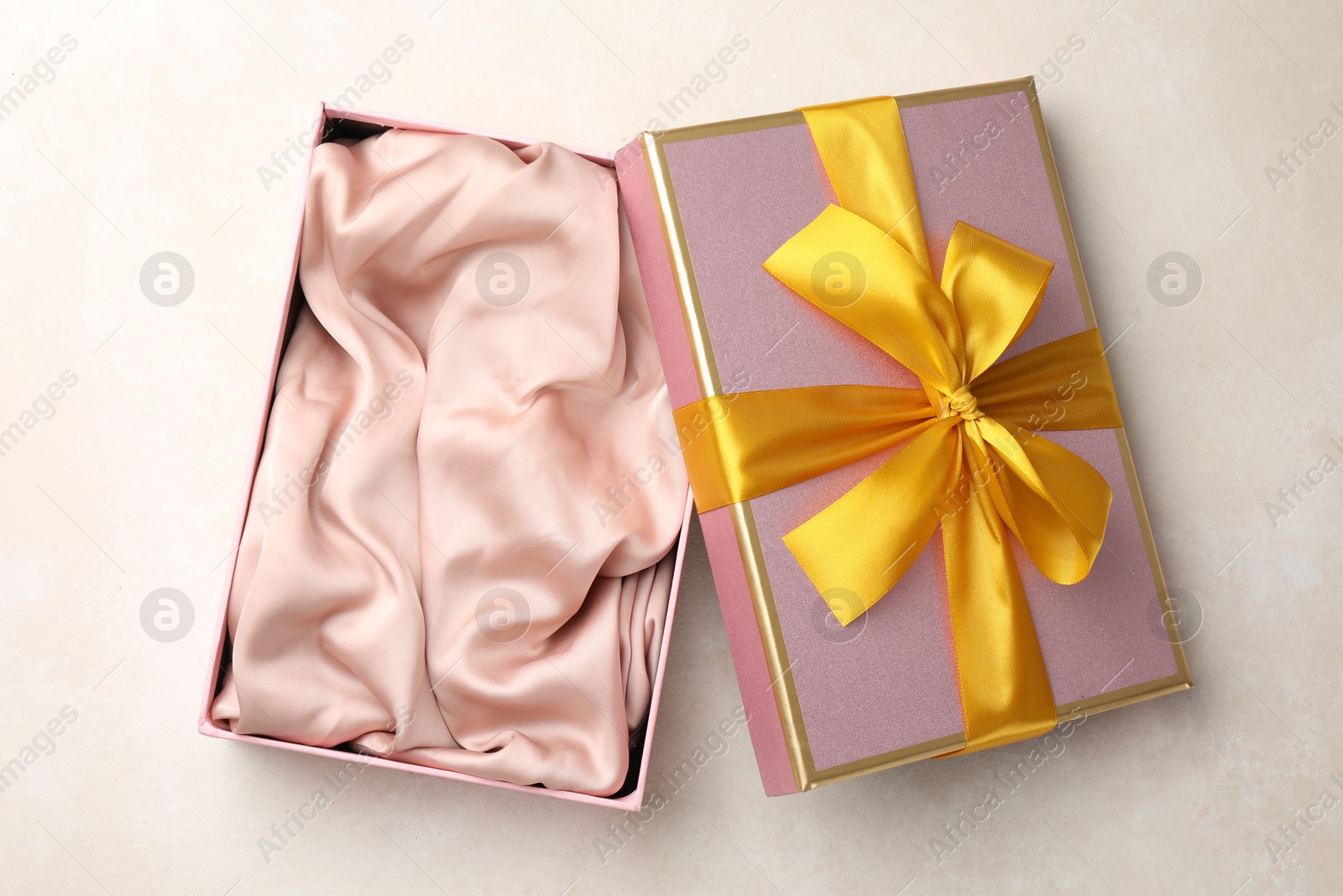 Photo of Open gift box with beautiful lid on light background, top view