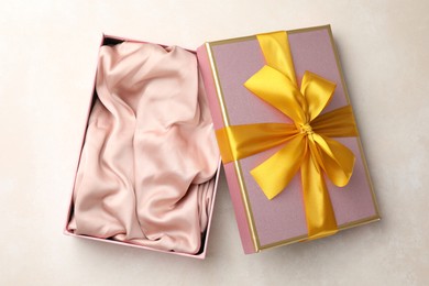 Photo of Open gift box with beautiful lid on light background, top view