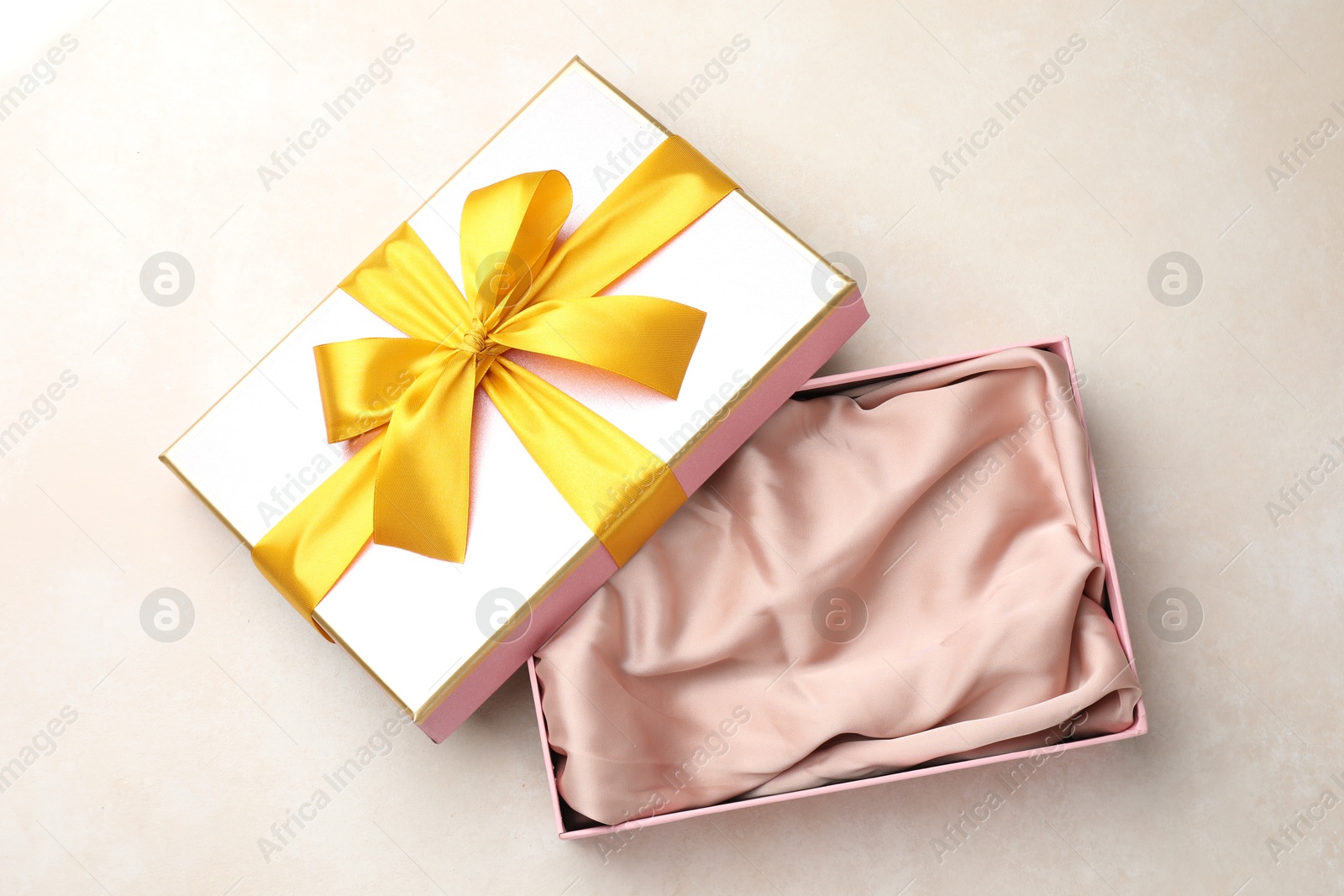 Photo of Open gift box with beautiful lid on light background, top view