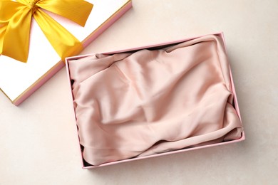 Photo of Open gift box with beautiful lid on light background, top view