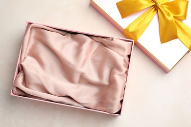 Photo of Open gift box with beautiful lid on light background, top view