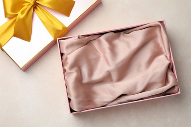 Photo of Open gift box with beautiful lid on light background, top view