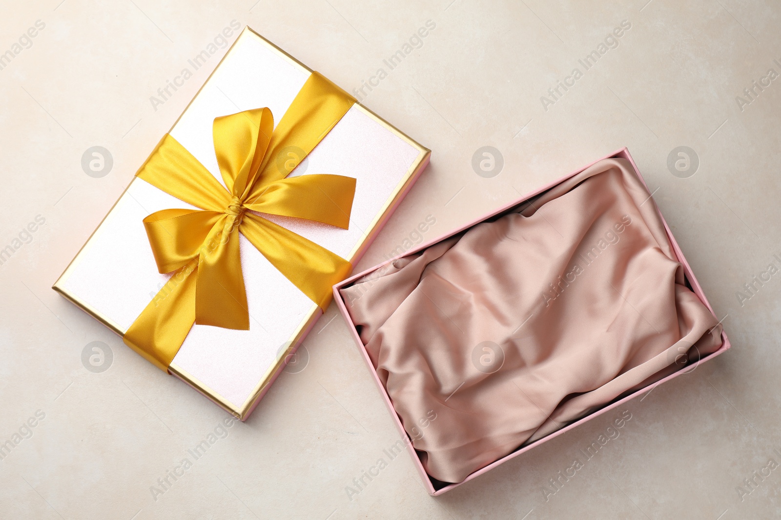 Photo of Open gift box with beautiful lid on light background, top view