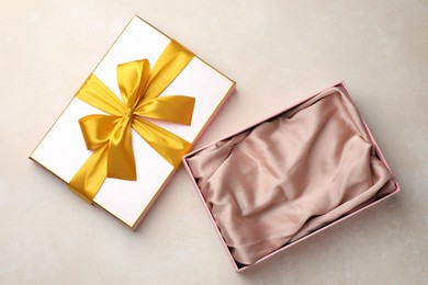 Photo of Open gift box with beautiful lid on light background, top view
