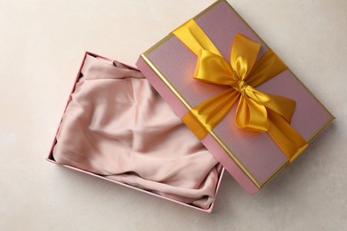 Photo of Open gift box with beautiful lid on light background, top view