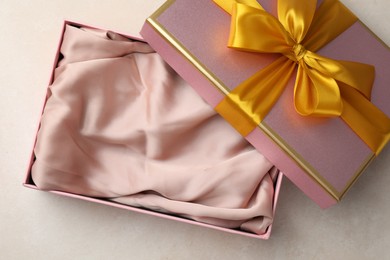 Photo of Open gift box with beautiful lid on light background, top view