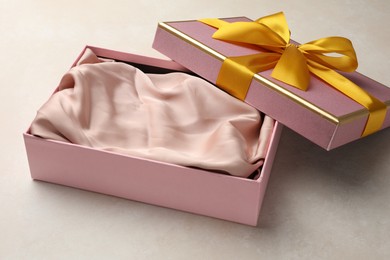 Photo of Open gift box with beautiful lid on light background
