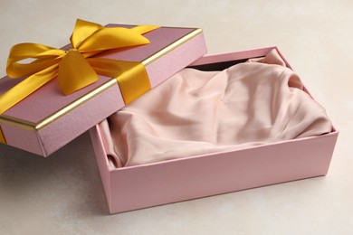 Photo of Open gift box with beautiful lid on light background