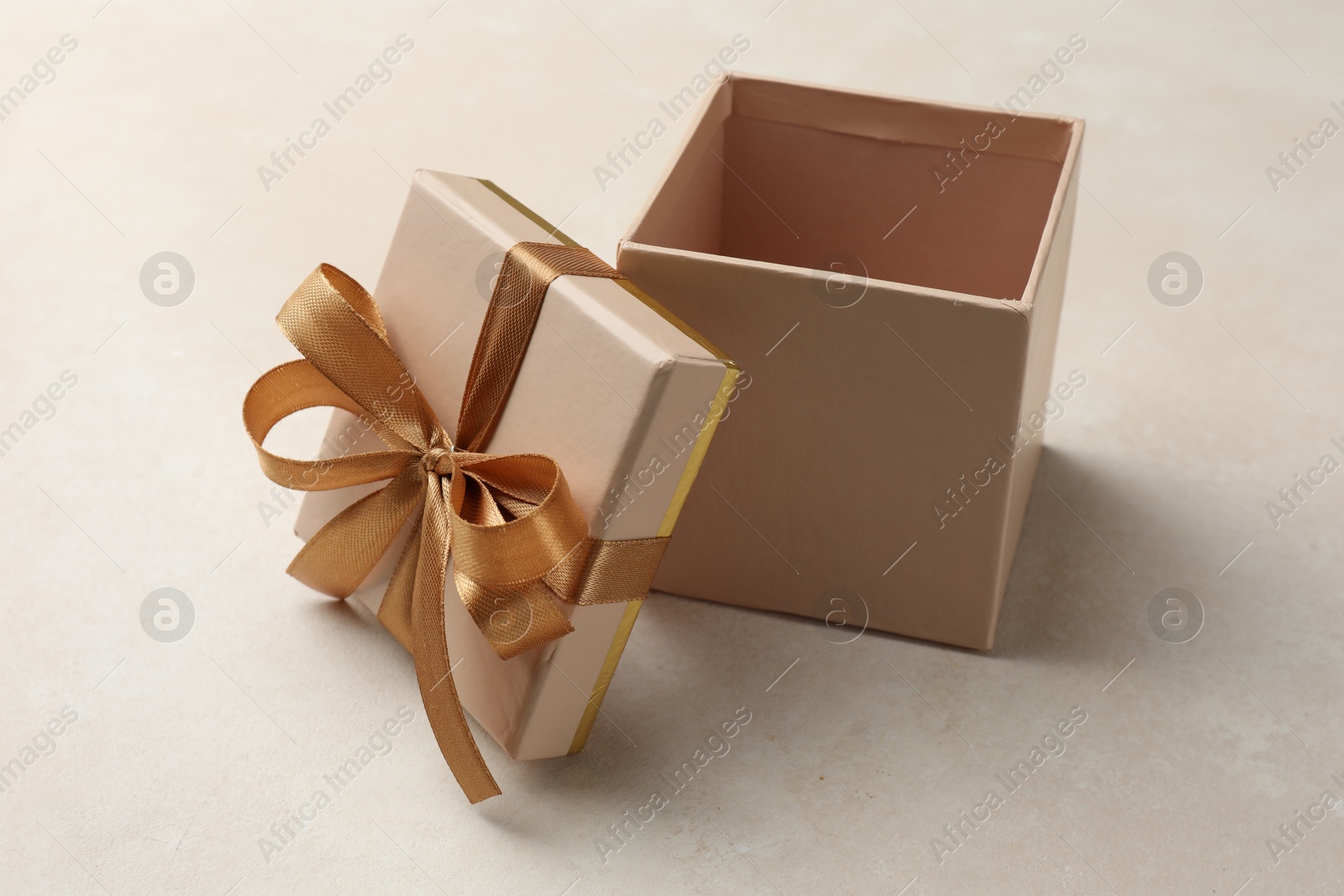Photo of Open gift box with beautiful lid on light background