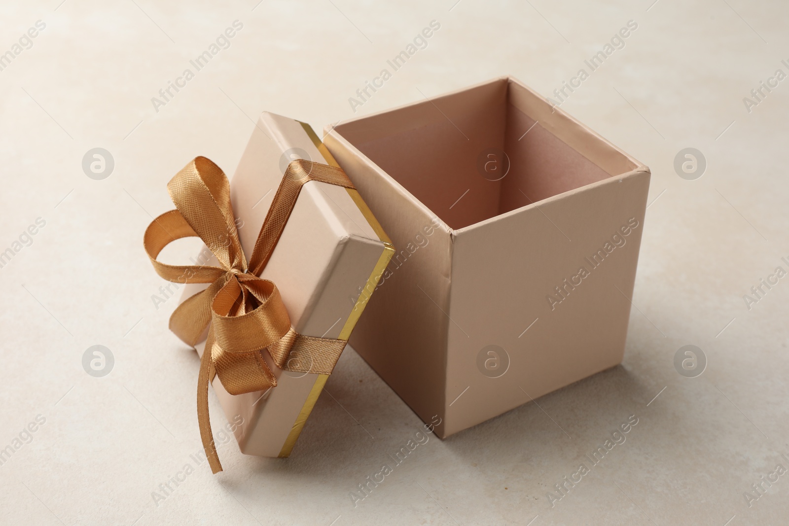 Photo of Open gift box with beautiful lid on light background