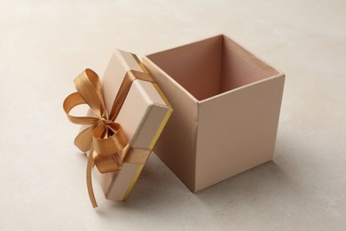 Photo of Open gift box with beautiful lid on light background
