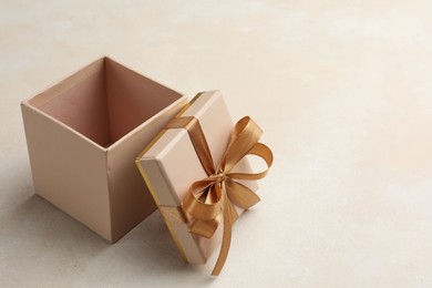 Photo of Open gift box with beautiful lid on light background, space for text