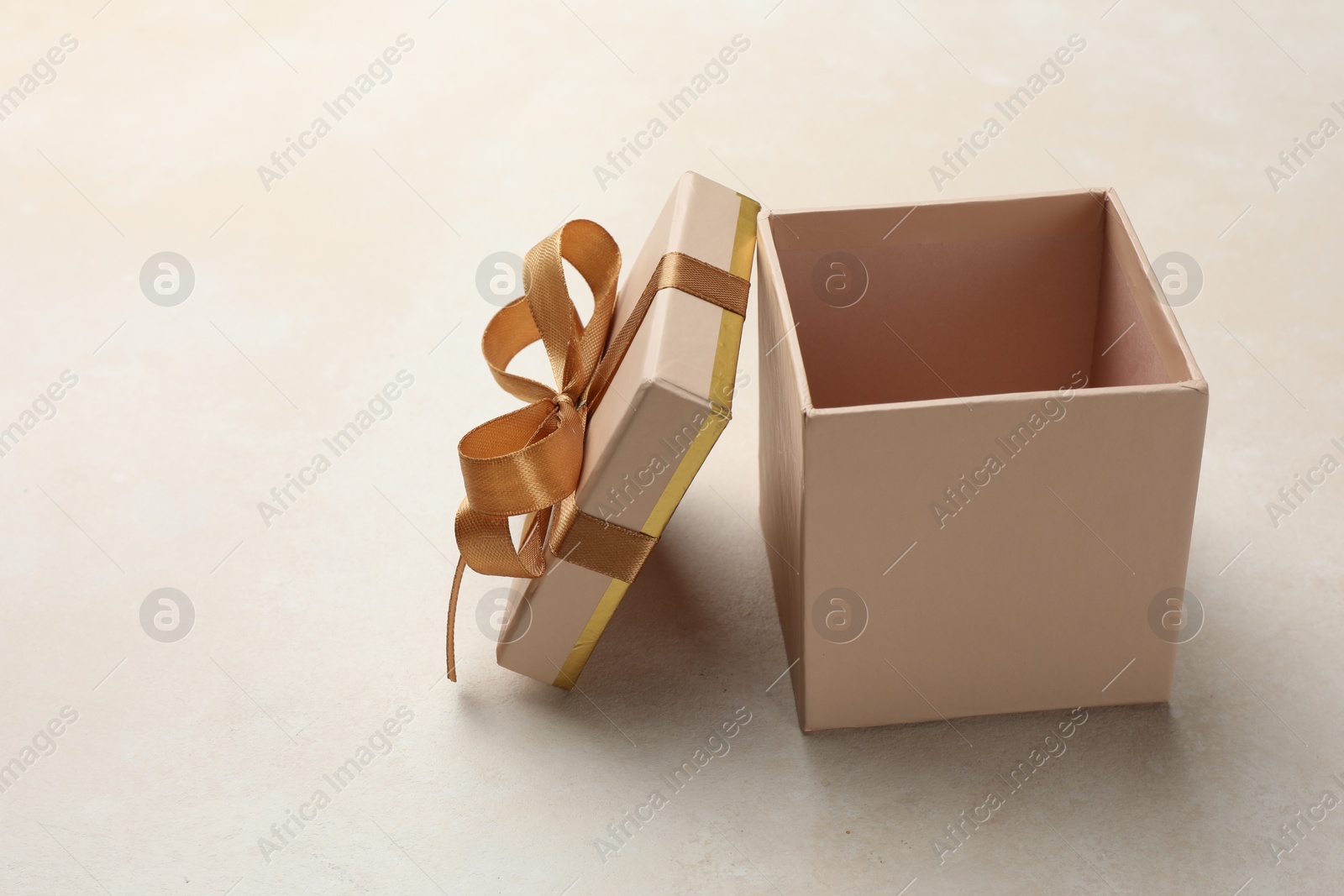 Photo of Open gift box with beautiful lid on light background, space for text